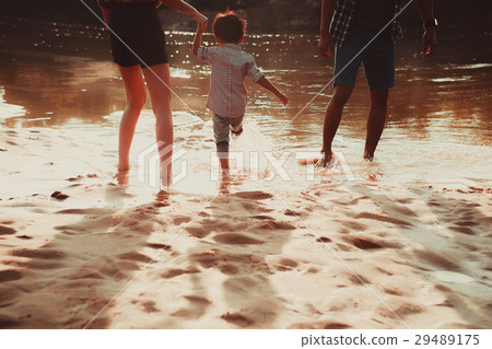 father mother and son on a sandy beach family 29489175