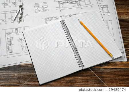Open blueprints on wooden table background with a 29489474