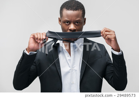 Afroamerican guy with closed mouth shows ignorance Afroamerican guy with closed mouth shows ignorance 29489573