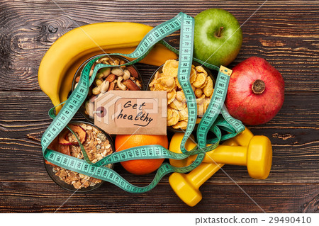 Fruits, nuts and measuring tape. 29490410