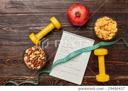 Dumbbells and notebook. 29490437