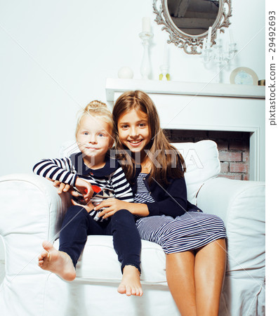 two cute sisters at home interior playing, little two cute sisters at home interior playing, little 29492693