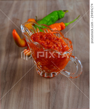 Tabasco adjika in a glass gravy boat, hot pepper Tabasco adjika in a glass gravy boat, hot pepper 29494274
