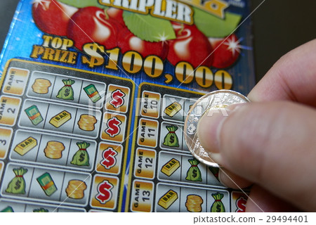 Close up man scratching lottery ticket. 29494401
