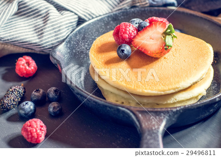 Home made pancakes with berries on metal Home made pancakes with berries on metal 29496811