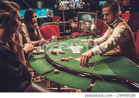 Upper class friends gambling in a casino Upper class friends gambling in a casino 29499586