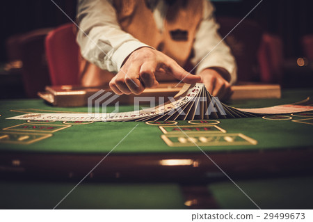 Croupier behind gambling table in a casino Croupier behind gambling table in a casino 29499673