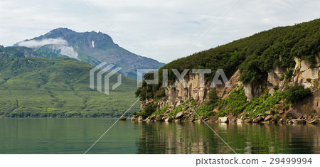 Beautiful coast of Kurile Lake is reflected in the 29499994