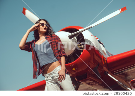 Woman pilot and airplane 29500420