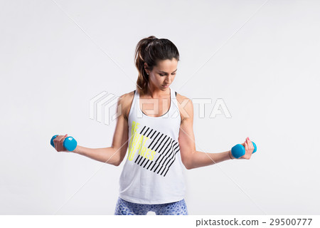 Attractive young fitness woman holding dumbells 29500777