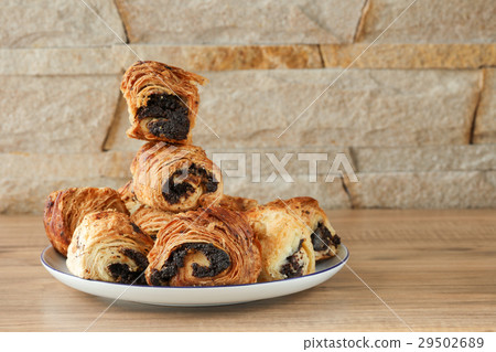 Sweet rolls with poppy seeds on a white plate 29502689