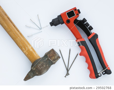 Old hammer, nails against new Rivet Gun and Rivets 29502768