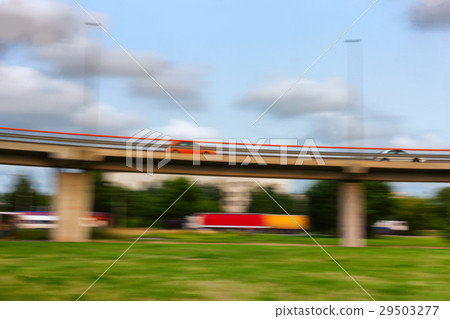 Cars go fast on a bridge on a summer day. Blurry Cars go fast on a bridge on a summer day. Blurry 29503277