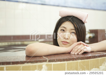 A woman standing on a public bath girl bathtub 29505201