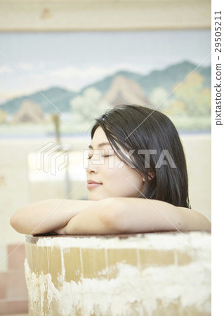 A woman standing on a public bath girl bathtub 29505211