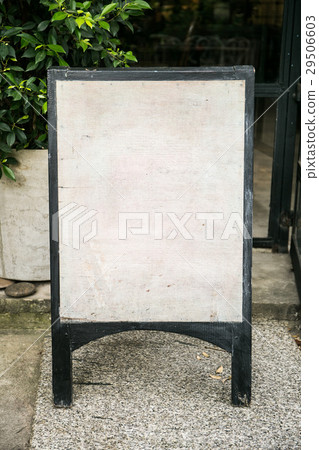 Empty, wooden sign in front of a shop Empty, wooden sign in front of a shop 29506603