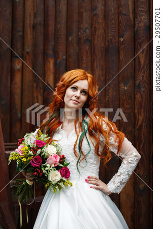 Boho bride with red hair posing 29507701