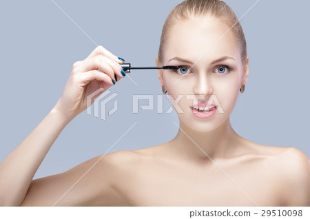 beautiful blond woman applying makeup on face on beautiful blond woman applying makeup on face on 29510098