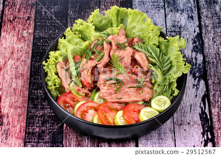 Spicy fried pork with herb in shrimp paste dip . Spicy fried pork with herb in shrimp paste dip . 29512567