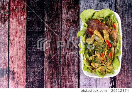 Green tilapia fish curry in coconut milk . 29512574