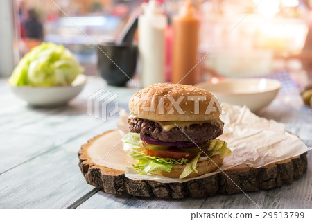 Burger on wood board. 29513799