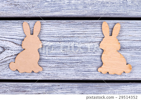 Wooden bunnies on grey background. Wooden bunnies on grey background. 29514352