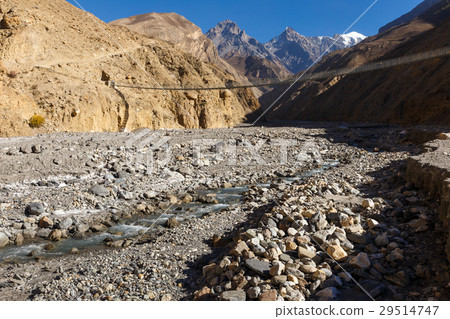 suspension bridge across mountain river, Himalayas 29514747