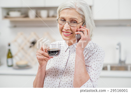Joyful senior housewife talking on phone in Joyful senior housewife talking on phone in 29516001
