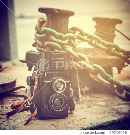 vintage camera near a mooring bollard on pier 29516036
