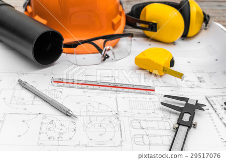 Construction plans with helmet and drawing tools on blueprints . 29517076