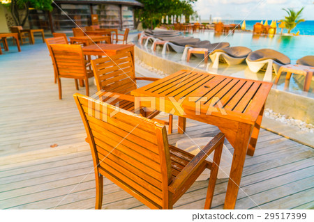 Table and chairs at restaurant in tropical Maldives island . Table and chairs at restaurant in tropical Maldives island . 29517399