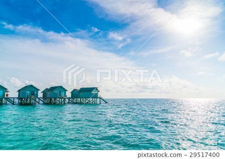 Beautiful water villas in tropical Maldives island at the sunset time . Beautiful water villas in tropical Maldives island at the sunset time . 29517400
