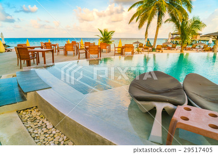 Table and chairs at restaurant in tropical Maldives island . Table and chairs at restaurant in tropical Maldives island . 29517405