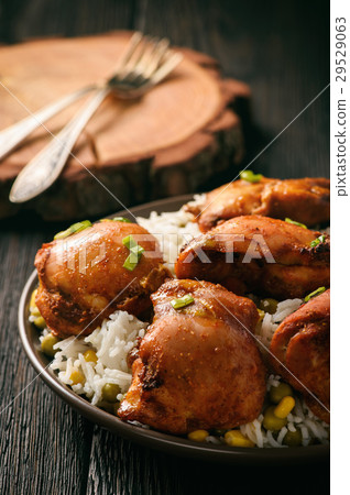 Chicken pieces baked in tomato sauce. 29529063