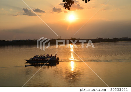 A Mekong River, a beautiful sunset and a Thai side sightseeing ship seen from Takeuk in the southern part of Laos A Mekong River, a beautiful sunset and a Thai side sightseeing ship seen from Takeuk in the southern part of Laos 29533921