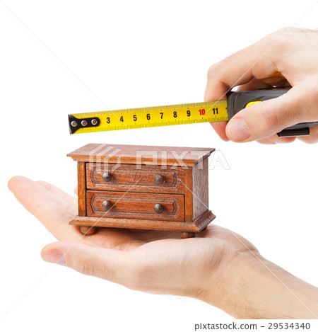 woodworker measuring chest of drawers  29534340