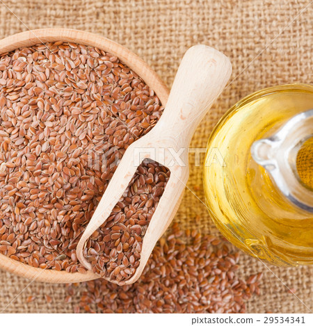 mortar of flax seeds  and linseed oil in jug 29534341