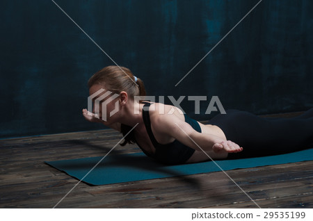 Young healthy woman practicing yoga indoors Young healthy woman practicing yoga indoors 29535199