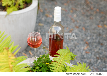 One glass and bottle of red or rose wine in One glass and bottle of red or rose wine in 29536870