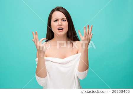 Frustrated young woman posing on blue Frustrated young woman posing on blue 29538403
