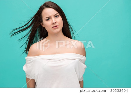 Frustrated young woman posing on blue Frustrated young woman posing on blue 29538404