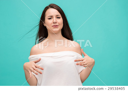 Frustrated young woman posing on blue Frustrated young woman posing on blue 29538405