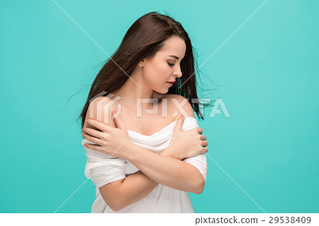 Frustrated young woman posing on blue Frustrated young woman posing on blue 29538409