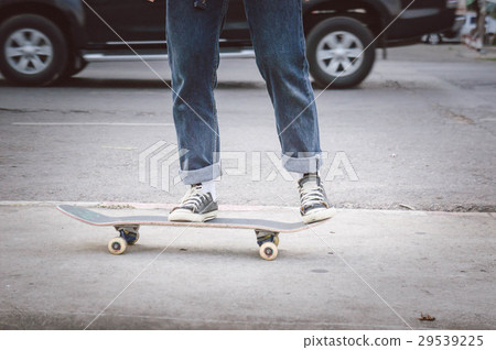 Teen skateboarding on the street Teen skateboarding on the street 29539225