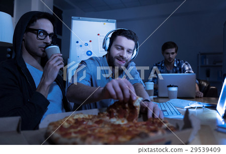 Nice handsome man taking a slice of pizza 29539409