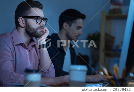 Handsome pensive programmer working on the 29539482