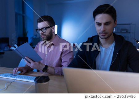 Intelligent male programmer reading a book 29539486