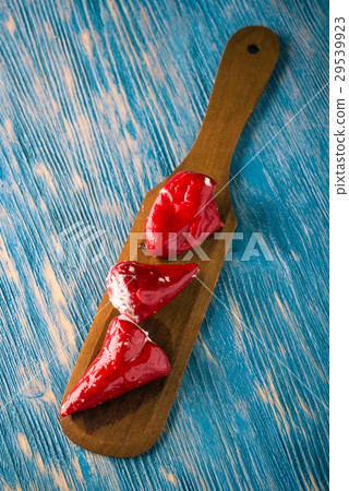 Three red hot chili pepper filled by cheese  29539923