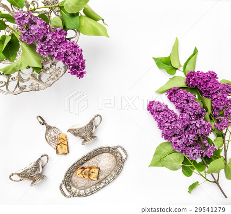 Lilac flowers. Coffee tea pie table dishes.   29541279
