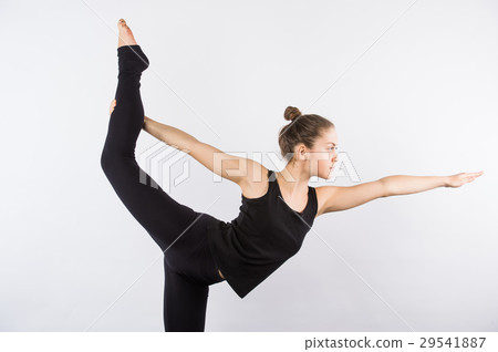 Attractive Woman doing Standing Bow Yoga Pose Attractive Woman doing Standing Bow Yoga Pose 29541887